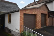 Verkauf Freistehendes Ein- bis Zweifamilienhaus mit viel Nebengelass Ansicht Garage 3 + 4